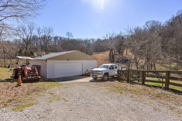 detached garage featuring fence