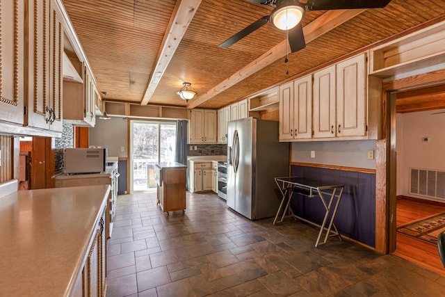 kitchen with wood ceiling, visible vents, a center island, open shelves, and stainless steel fridge