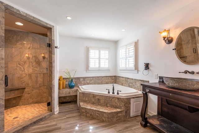 bathroom featuring a stall shower, vanity, recessed lighting, and a bath