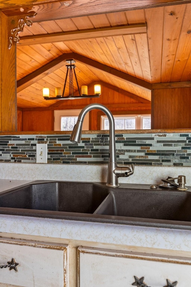 room details featuring wooden ceiling, backsplash, a sink, and beamed ceiling