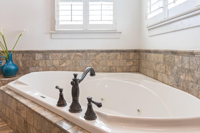 full bath featuring plenty of natural light and a whirlpool tub