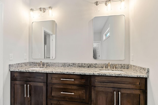 full bath featuring double vanity and a sink