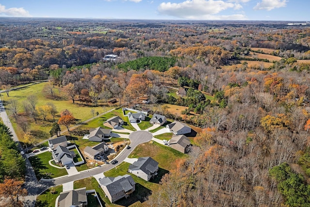 aerial view with a wooded view and a residential view