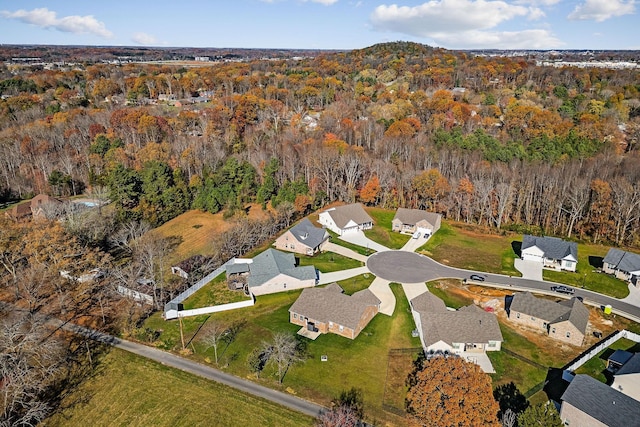 drone / aerial view with a forest view and a residential view