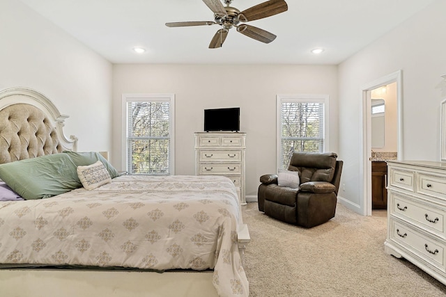 bedroom with recessed lighting, light colored carpet, baseboards, and multiple windows