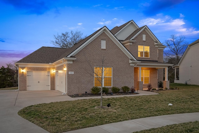 view of front of property with driveway, a shingled roof, an attached garage, a front yard, and brick siding