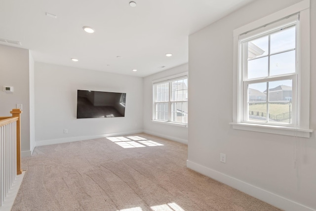 unfurnished living room with carpet, visible vents, baseboards, and recessed lighting