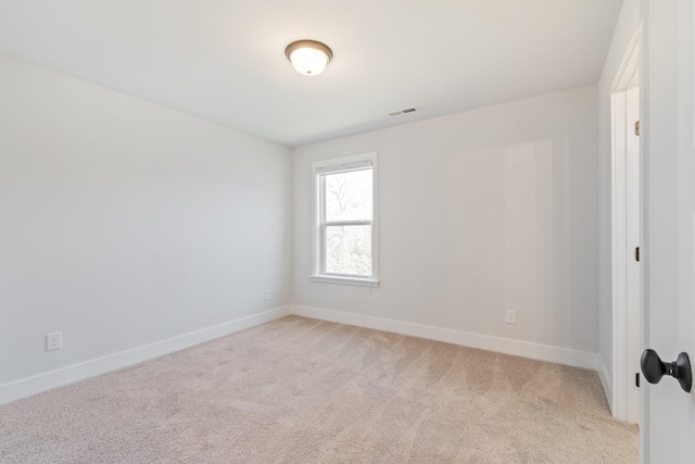 unfurnished room with light carpet, visible vents, and baseboards