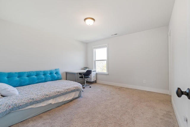 carpeted bedroom with visible vents and baseboards