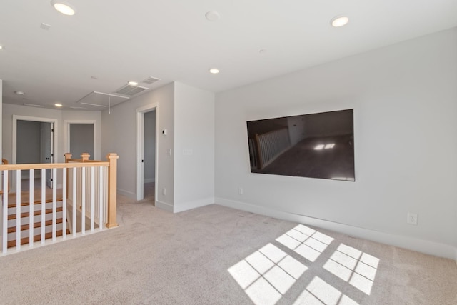 carpeted empty room with attic access, recessed lighting, visible vents, and baseboards