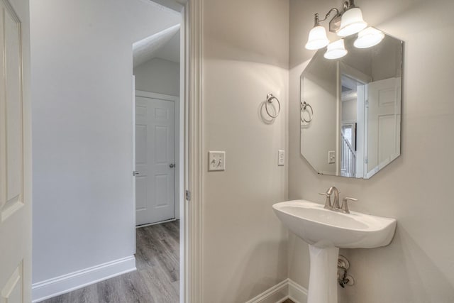 bathroom with wood finished floors and baseboards