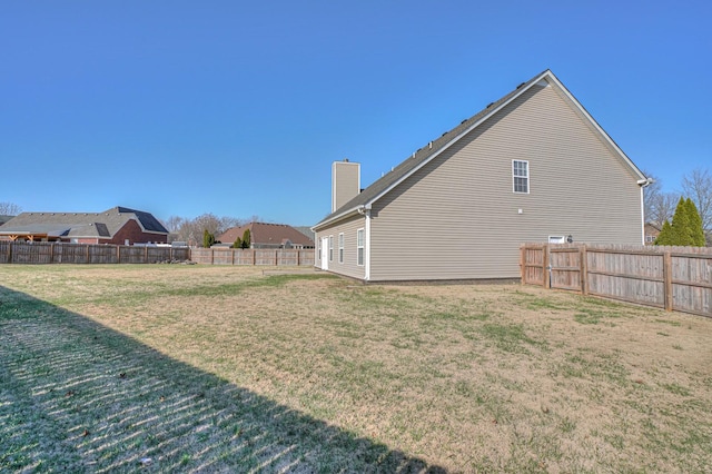 view of yard with a fenced backyard