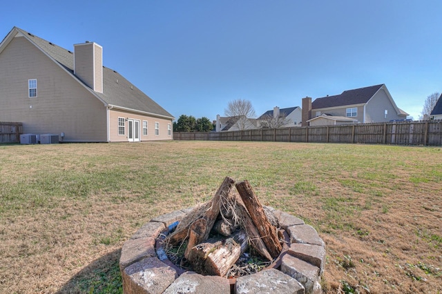 view of yard featuring central AC unit and a fenced backyard