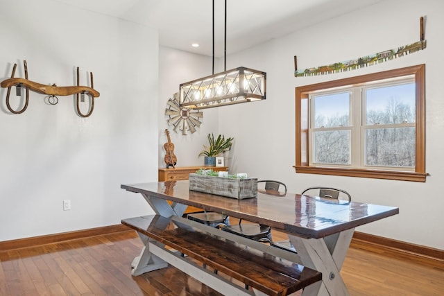 dining space featuring wood-type flooring, baseboards, and recessed lighting