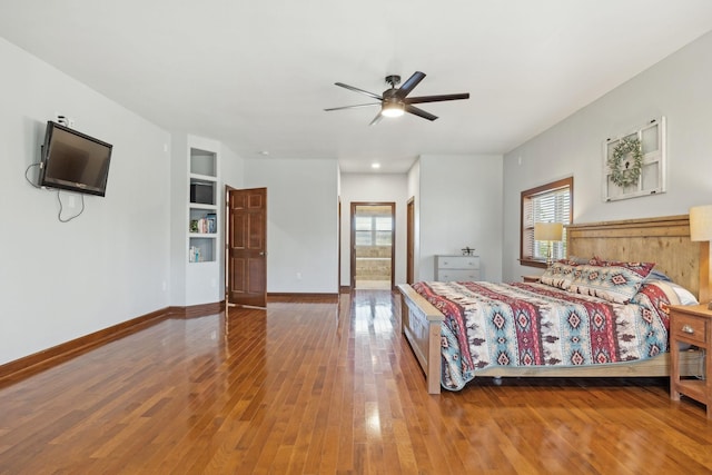 bedroom featuring ensuite bathroom, ceiling fan, hardwood / wood-style floors, and baseboards