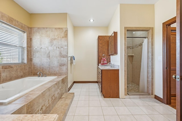 bathroom with tile patterned flooring, a garden tub, a shower stall, and vanity