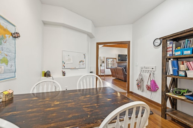 dining space featuring baseboards and wood finished floors