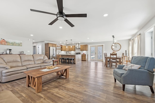 living area with ceiling fan, french doors, wood finished floors, and recessed lighting