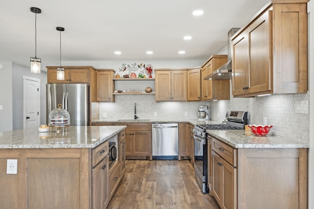 kitchen with a sink, appliances with stainless steel finishes, wall chimney range hood, dark wood-style floors, and open shelves