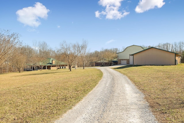 view of street featuring driveway and a pole building