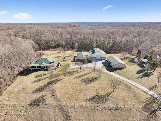 birds eye view of property featuring a rural view and a wooded view