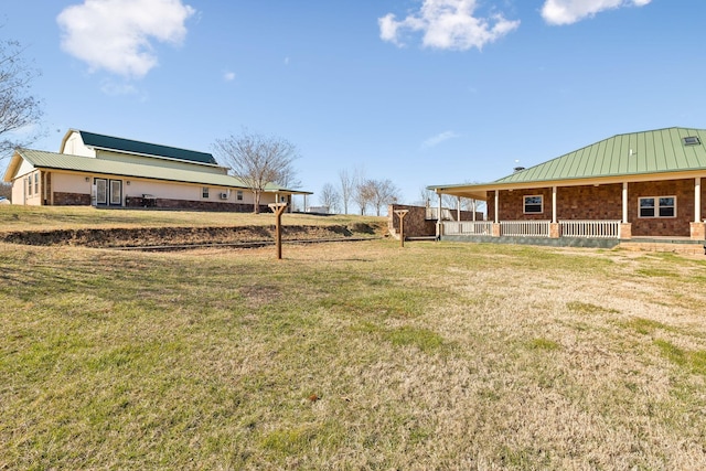 view of yard with covered porch