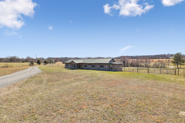 view of yard with a rural view and fence