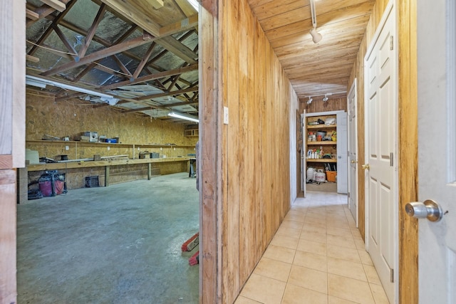 hallway featuring tile patterned flooring and wood ceiling