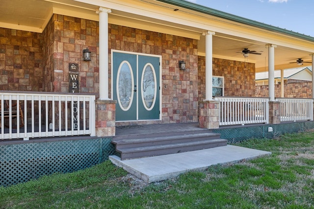 entrance to property featuring stone siding and covered porch