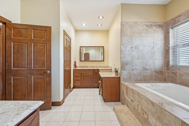 bathroom with recessed lighting, a garden tub, vanity, and tile patterned floors