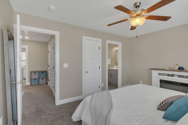 bedroom with a ceiling fan, carpet, baseboards, and connected bathroom