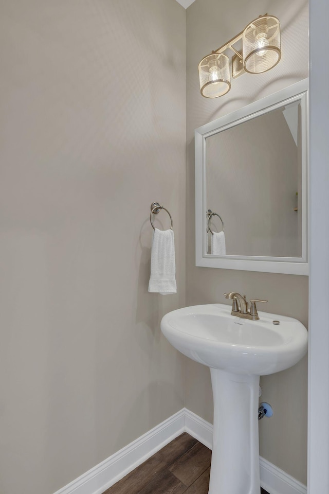 bathroom with baseboards and wood finished floors