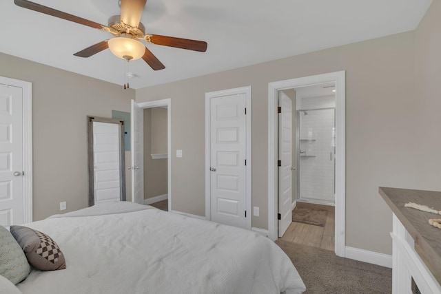 carpeted bedroom with ceiling fan, connected bathroom, and baseboards