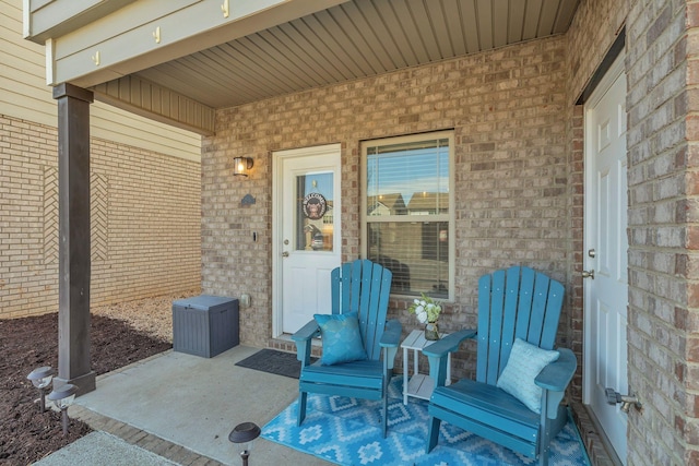 doorway to property featuring brick siding