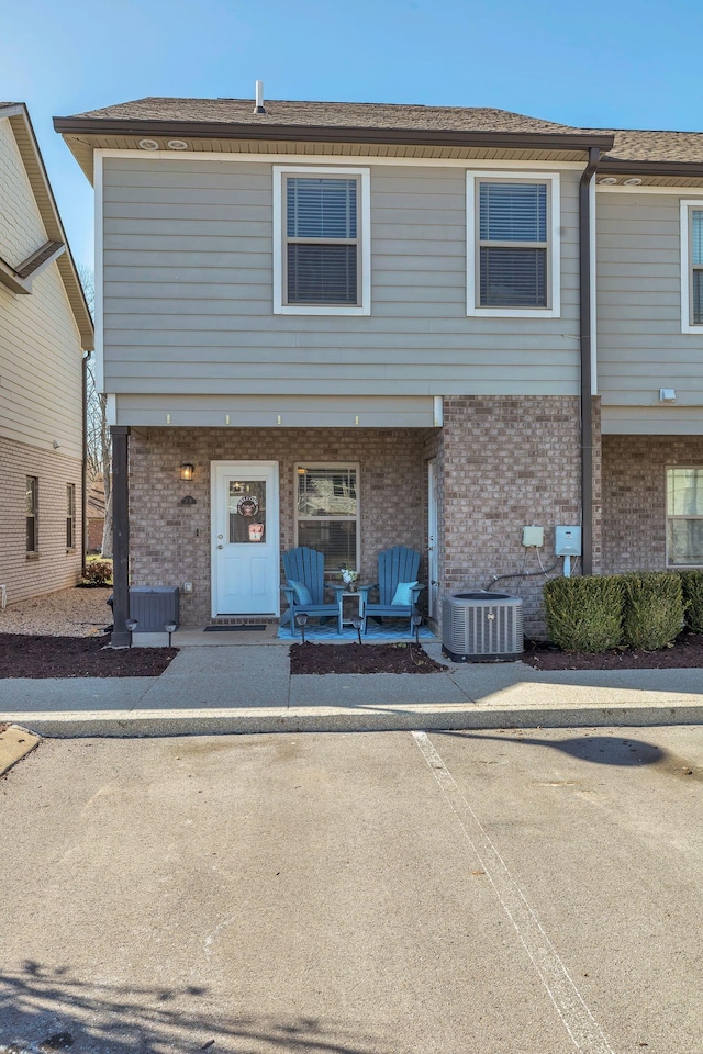 multi unit property featuring brick siding and central AC