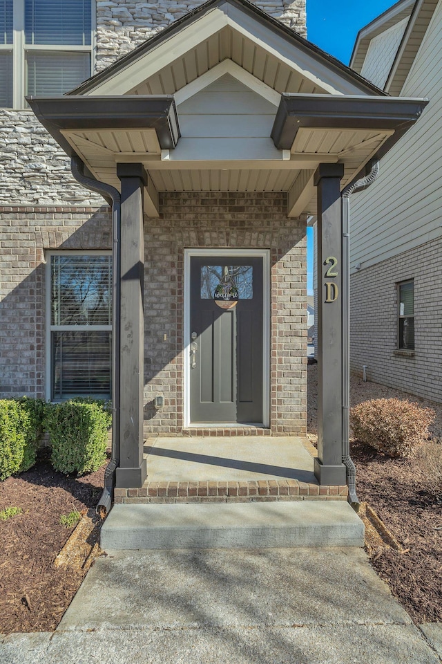 property entrance featuring brick siding