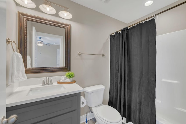 bathroom featuring shower / bath combo, vanity, and toilet