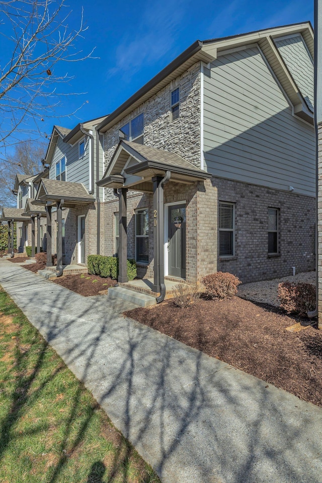 view of front facade with stone siding and brick siding