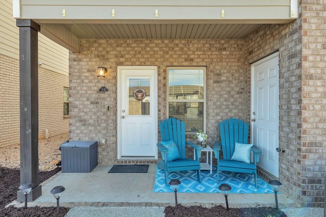 view of exterior entry with brick siding