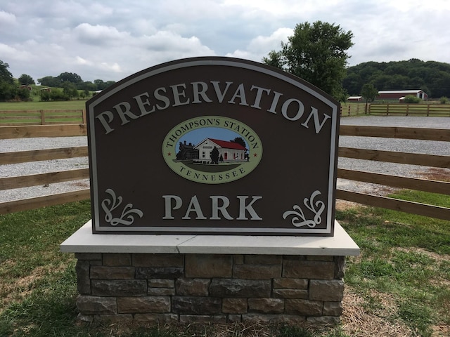 community / neighborhood sign featuring fence