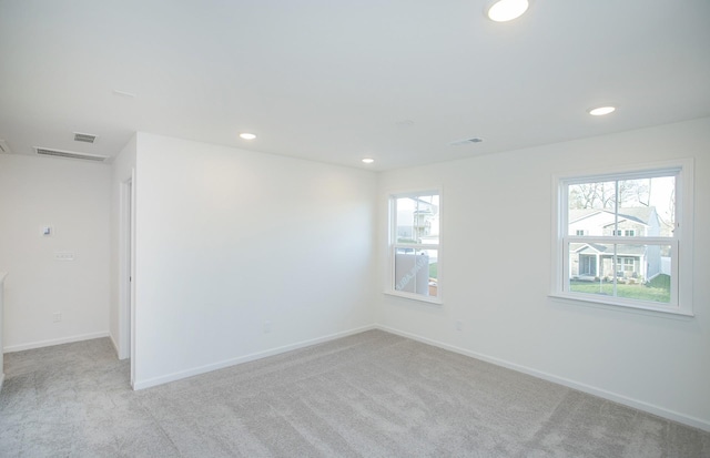 carpeted spare room with recessed lighting, a healthy amount of sunlight, and baseboards