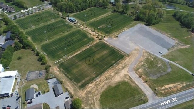 birds eye view of property with a rural view