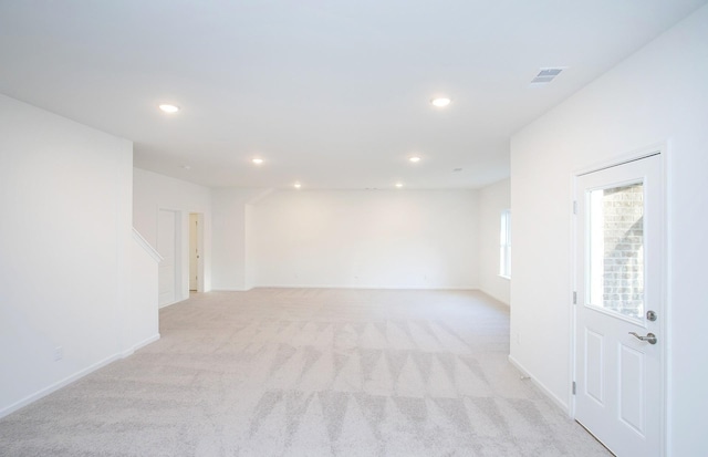 empty room with light carpet, baseboards, visible vents, and recessed lighting