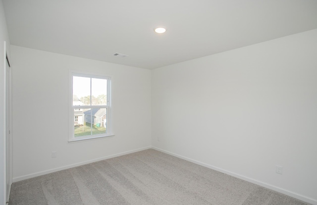 unfurnished room featuring recessed lighting, carpet flooring, visible vents, and baseboards