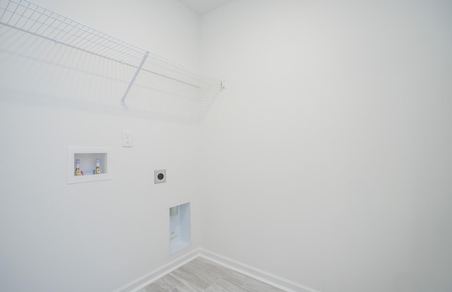 washroom featuring laundry area, hookup for a washing machine, baseboards, and hookup for an electric dryer