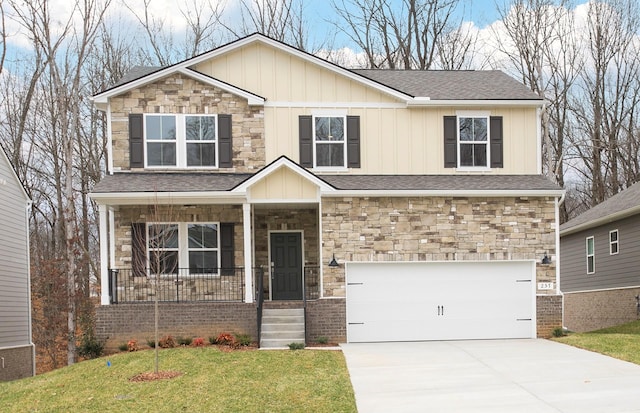 view of front of home with a front yard, driveway, a porch, an attached garage, and board and batten siding