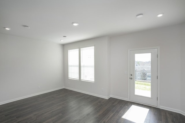 interior space with recessed lighting, dark wood finished floors, and baseboards