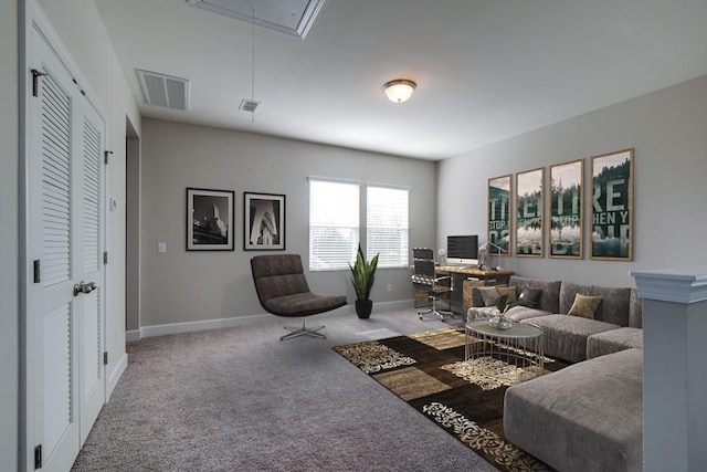 carpeted living room with visible vents, attic access, and baseboards