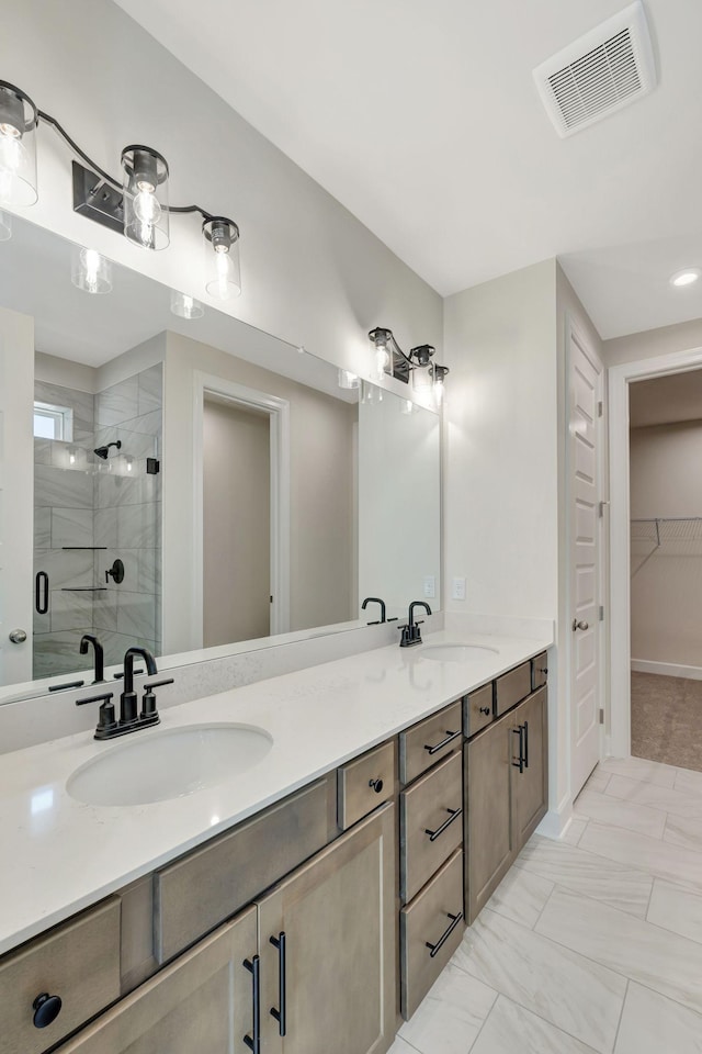 full bathroom featuring a sink, visible vents, a stall shower, and double vanity