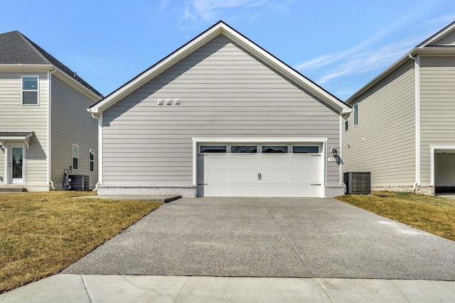 view of home's exterior with a yard, an attached garage, concrete driveway, and central AC